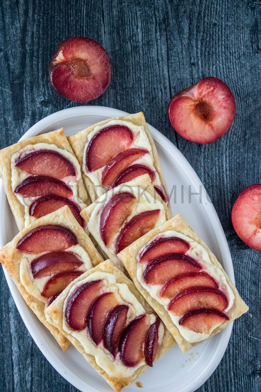 Semi-Exclusive Plum Puff Pastry Tart on Weathered Wood