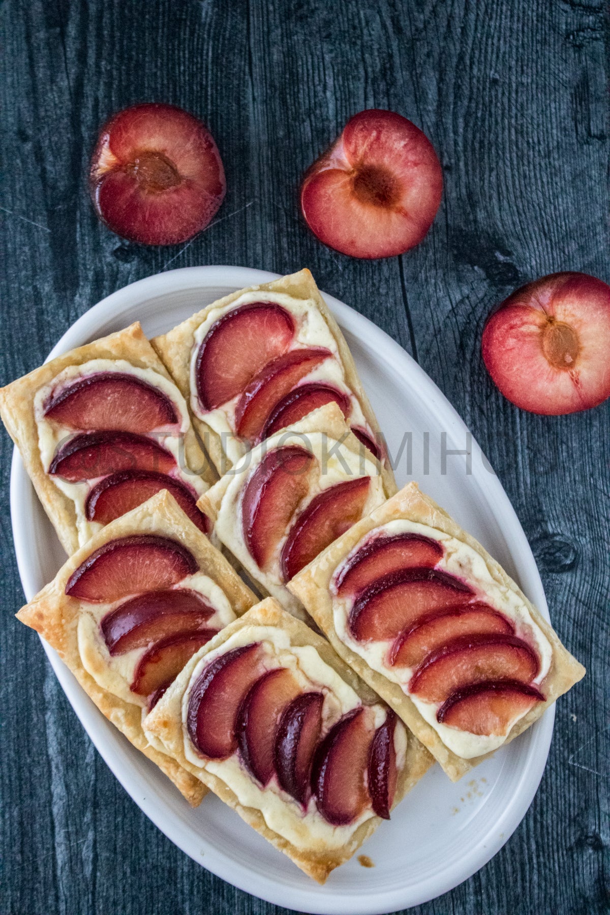 Semi-Exclusive Plum Puff Pastry Tart on Weathered Wood