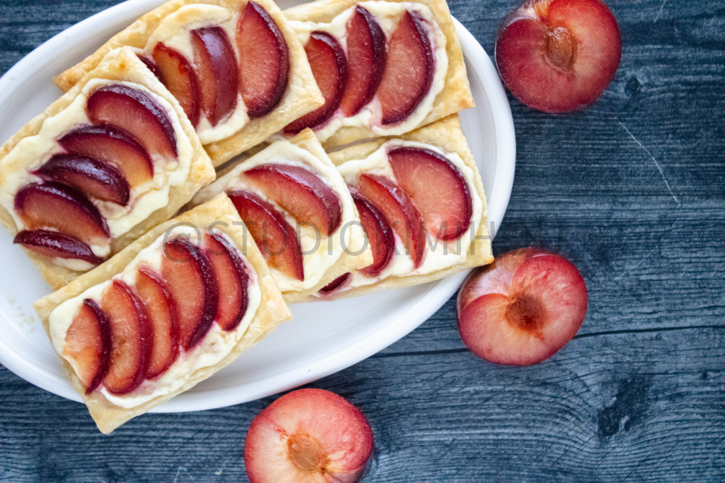 Semi-Exclusive Plum Puff Pastry Tart on Weathered Wood