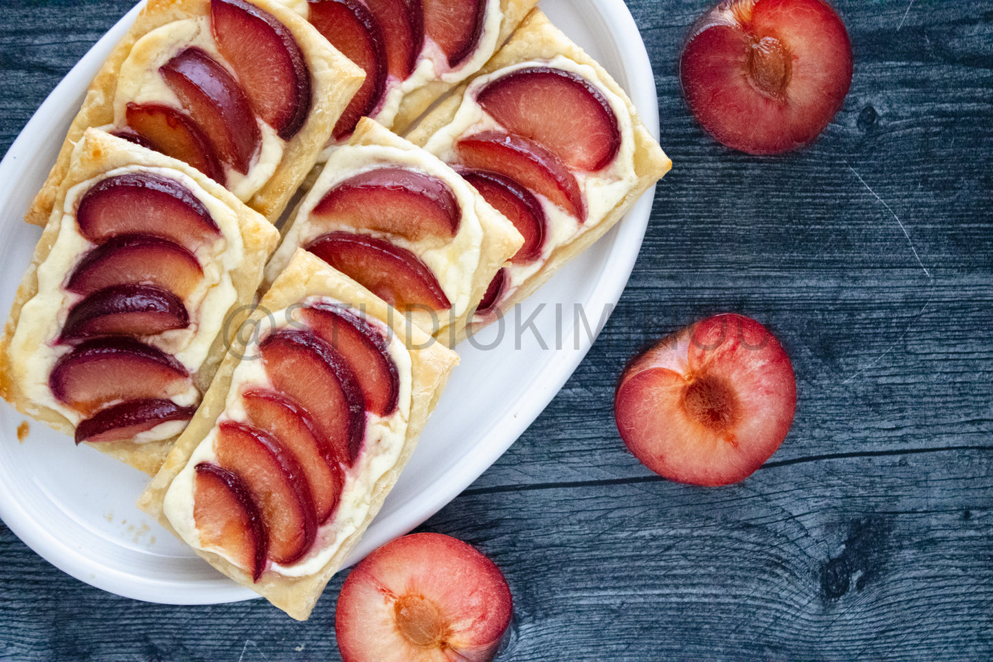 Semi-Exclusive Plum Puff Pastry Tart on Weathered Wood