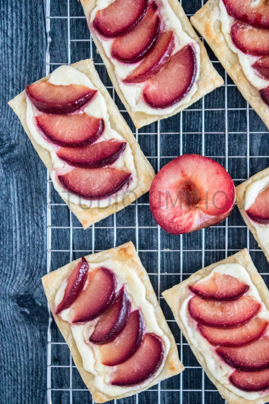 Semi-Exclusive Plum Puff Pastry Tart on Weathered Wood