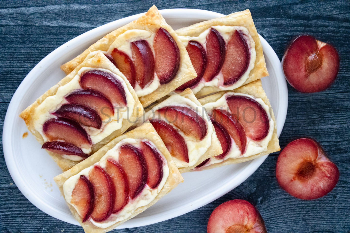 Semi-Exclusive Plum Puff Pastry Tart on Weathered Wood
