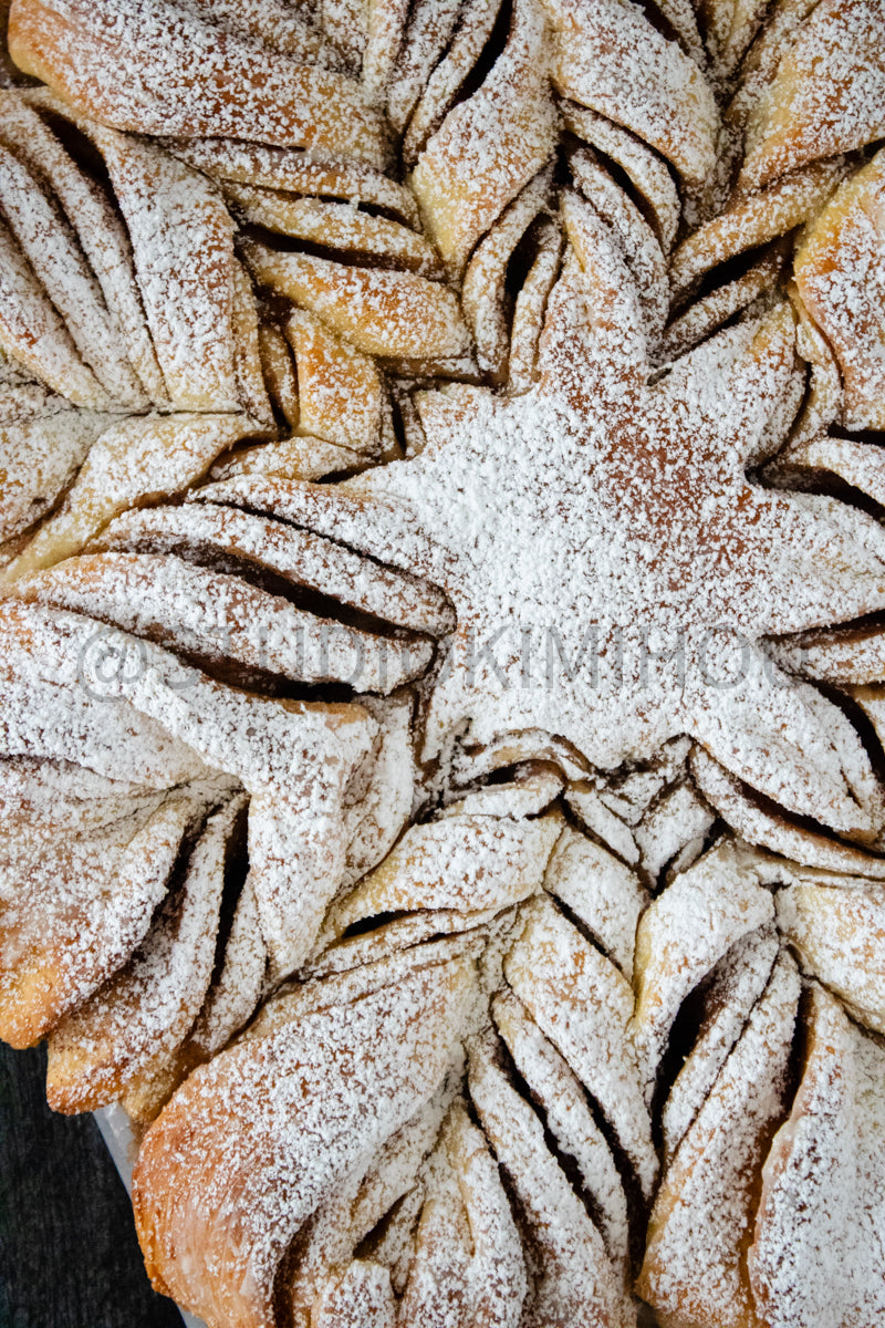 Semi-Exclusive Cinnamon Roll Snowflake on Weathered Wood